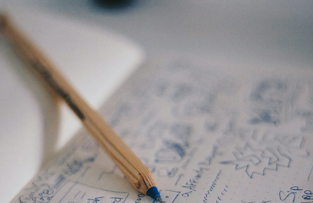 blue ballpoint pen on white notebook